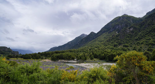 Scenic view of lake and mountains against sky