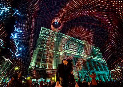 Low angle view of people in illuminate bauble at manezhnaya square