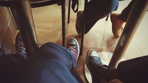 Low section of friends sitting in restaurant