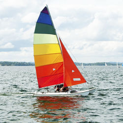 Sailboat sailing in sea against sky