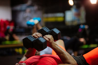 Midsection of man exercising at gym