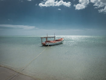 Sailboat in sea against sky