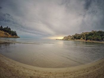 View of beach against cloudy sky