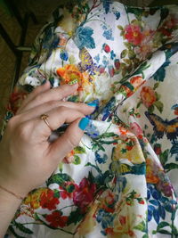 High angle view of woman hand on multi colored flowers