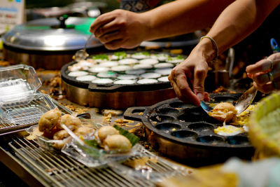 Midsection of man preparing food