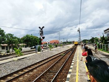 Train at railroad station against sky