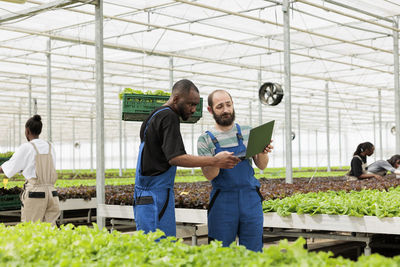 Portrait of young man holding plant