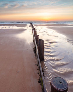 Scenic view of beach against sky during sunset