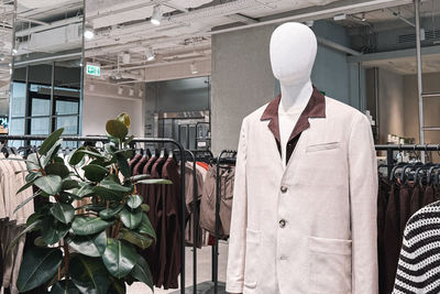Rear view of woman standing in greenhouse