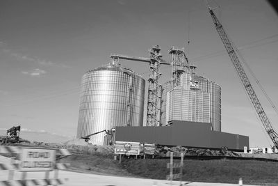 Low angle view of industry against sky