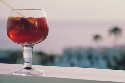 Close-up of drink on table against sea