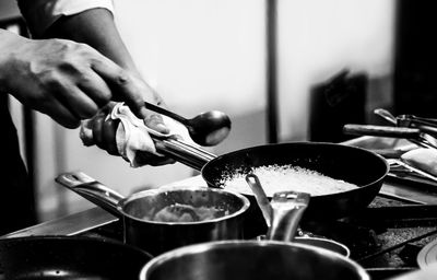 Midsection of man preparing food in kitchen