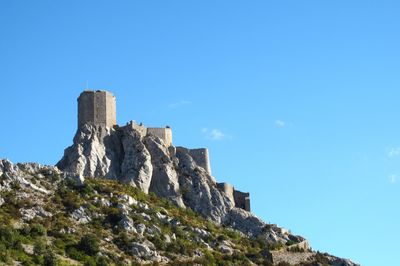 Low angle view of fort against clear blue sky