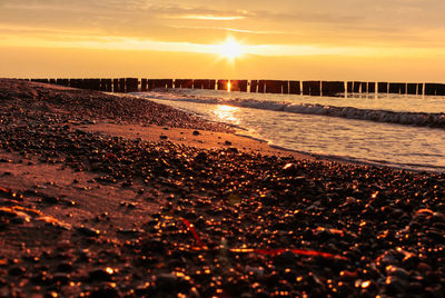 Scenic view of beach against sky during sunset