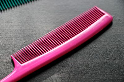High angle view of pink comb on table