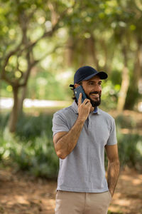 Young man at park on a beautiful sunny day with mobile phone.  working  leisure. green and nature 