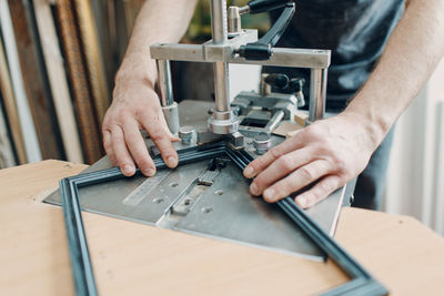 Midsection of man working at workshop