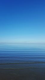 Scenic view of sea against blue sky