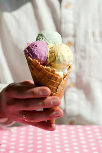 Close-up of hand holding ice cream cone