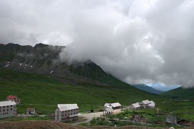 Panoramic view of building and mountains against sky