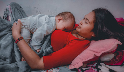 Rear view of mother and son sleeping