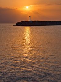 Scenic view of sea against orange sky