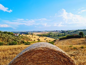 Typical summer landscape with hay bales and harvested wheat