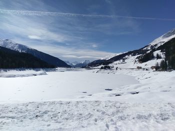 Scenic view of snow covered landscape against sky