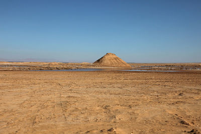 Scenic view of desert against clear sky