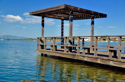 Pier on lake against sky