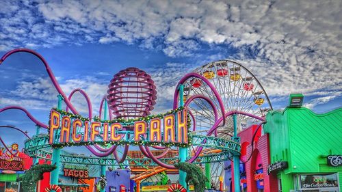 Low angle view of ferris wheel against sky