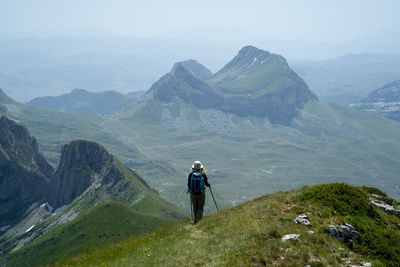 Rear view of man walking on mountain