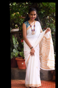 Portrait of a beautiful young woman standing outdoors