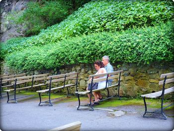 Man sitting on bench in park