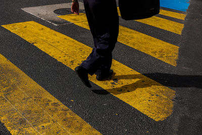 Low section of people walking on road