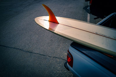 High angle view of surfboard in car on street