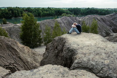 Rear view of man walking on rock