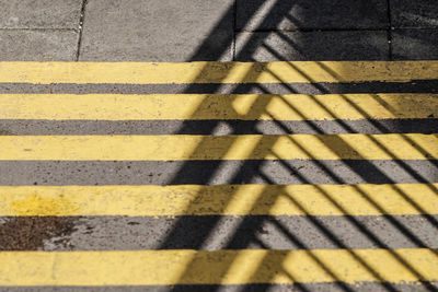 Shadow on yellow zebra crossing