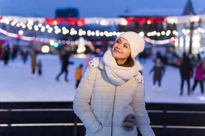 Portrait of smiling woman standing in city