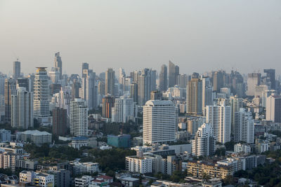 Aerial view of buildings in city against sky