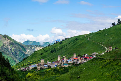 Scenic view of village in the mountains against sky