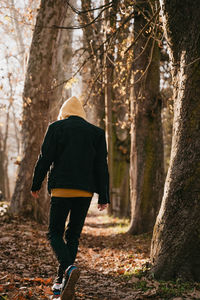 Rear view of man standing in forest