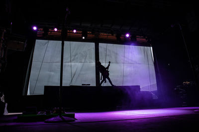 Silhouette people at illuminated nightclub