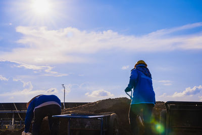 Rear view of man standing against sky