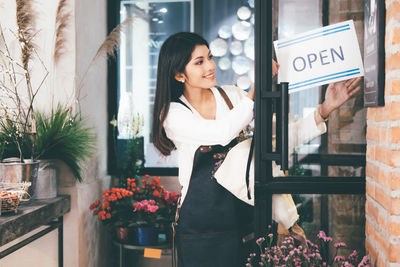 Woman standing by window at store