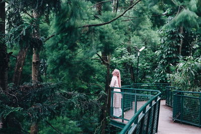 Woman standing in a forest