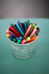 Close-up of colorful felt tip pens in container on table