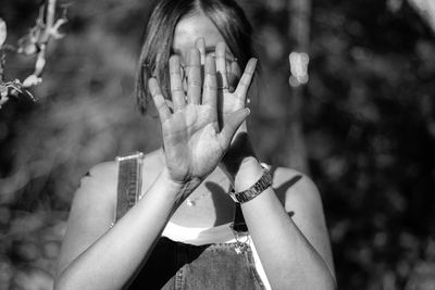 Woman covering face outdoors