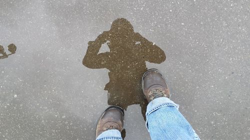 Low section of people standing in puddle