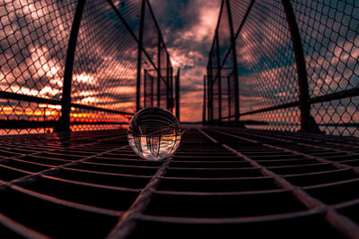 Close-up of metal fence at night